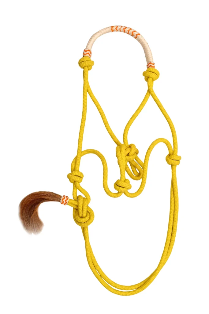 Rope Halter-Yellow - Yellow poly nylon rope horse halter featuring a decorative hair accent and full-size adjustable design. Built without hardware material, it...